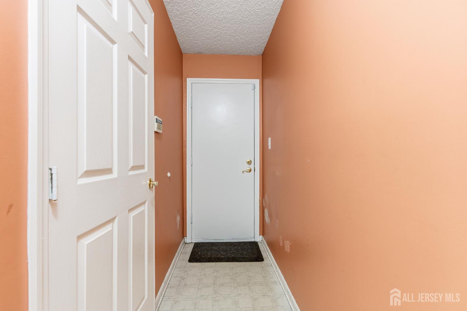 21 Newburgh Drive Edison, NJ 08820 - Photo 23 of 31 a view of a hallway with a white walls