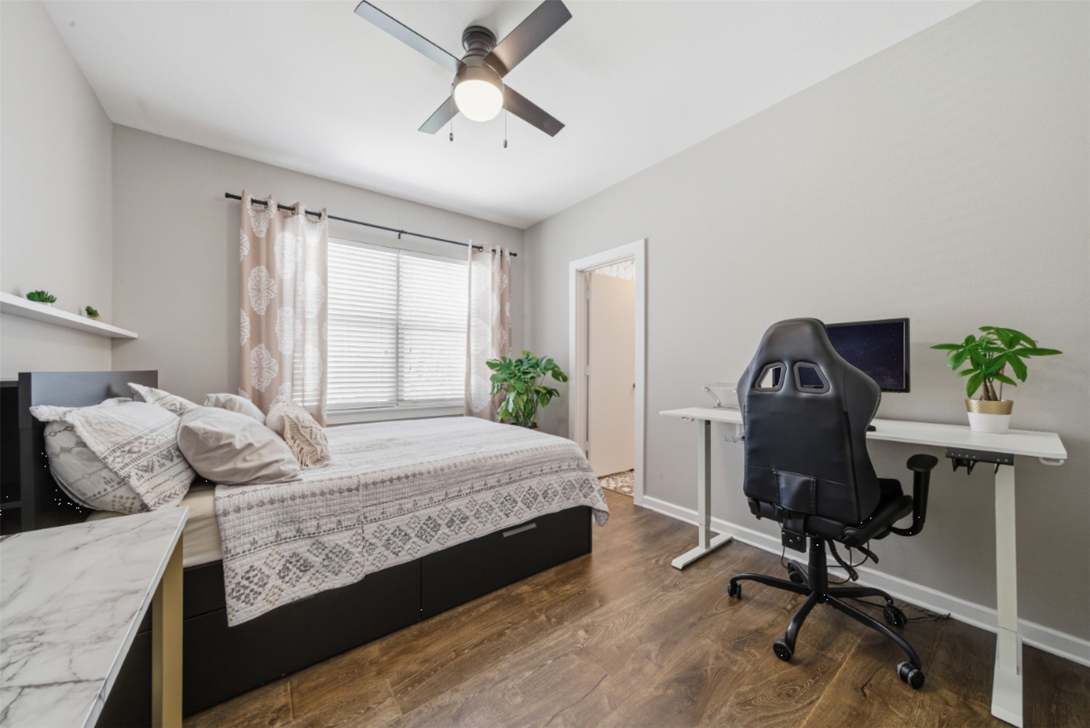 1201 Grove Boulevard, Unit 1304 Austin, TX 78741 - Photo 14 of 19 a bedroom with a bed a table and chair