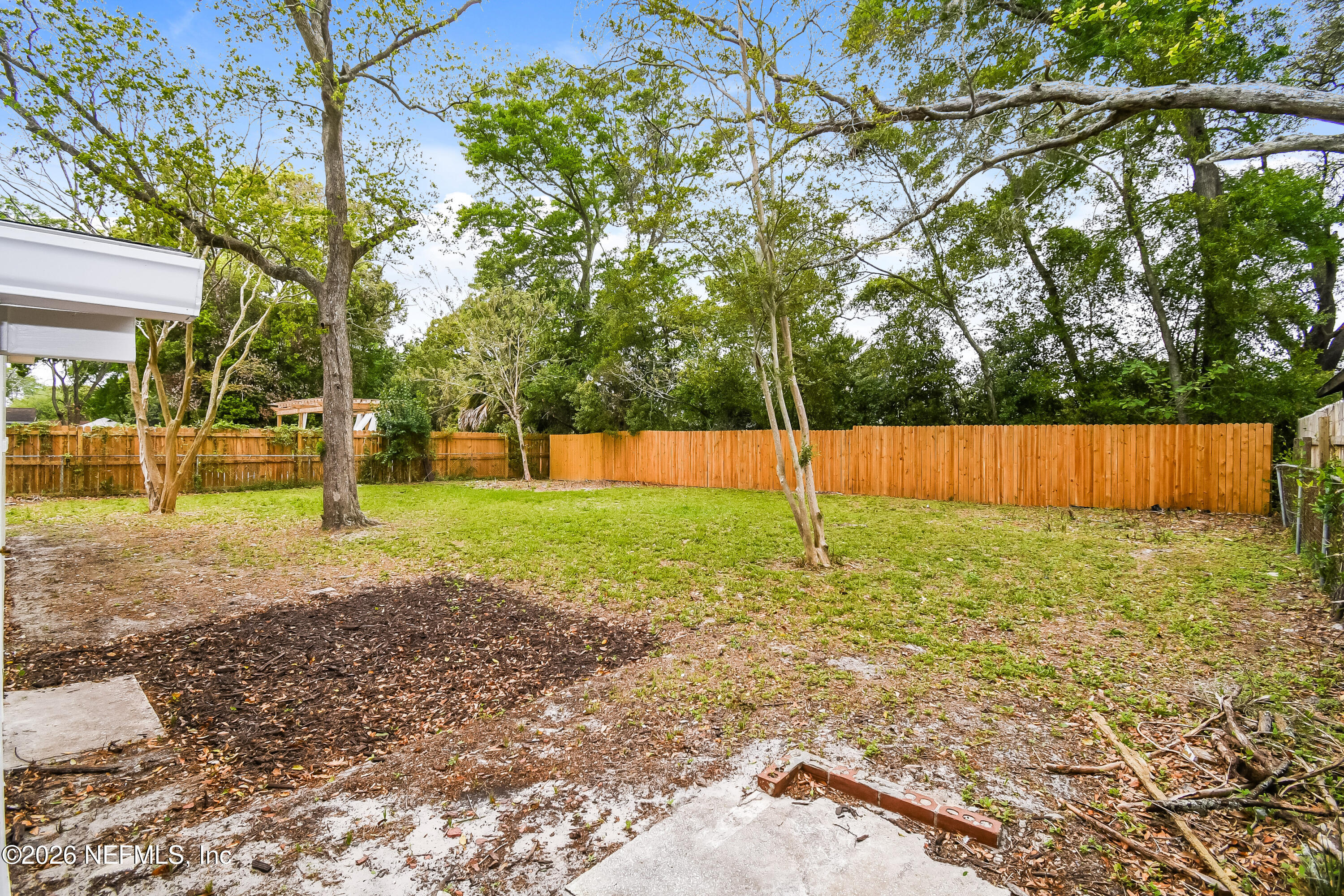 7227 Stonehurst Road North Jacksonville, FL 32277 - Photo 14 of 16 a view of a yard with a tree