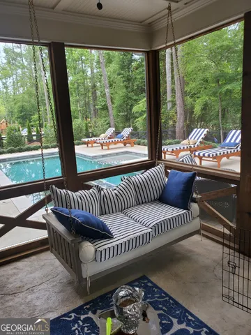 a living room with furniture and a floor to ceiling window
