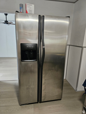 744 Royal Street Helper, UT 84526 - Photo 12 of 33 Kitchen view of stainless steel fridge with ice dispenser, light wood-type flooring, ceiling fan, and a textured wall
