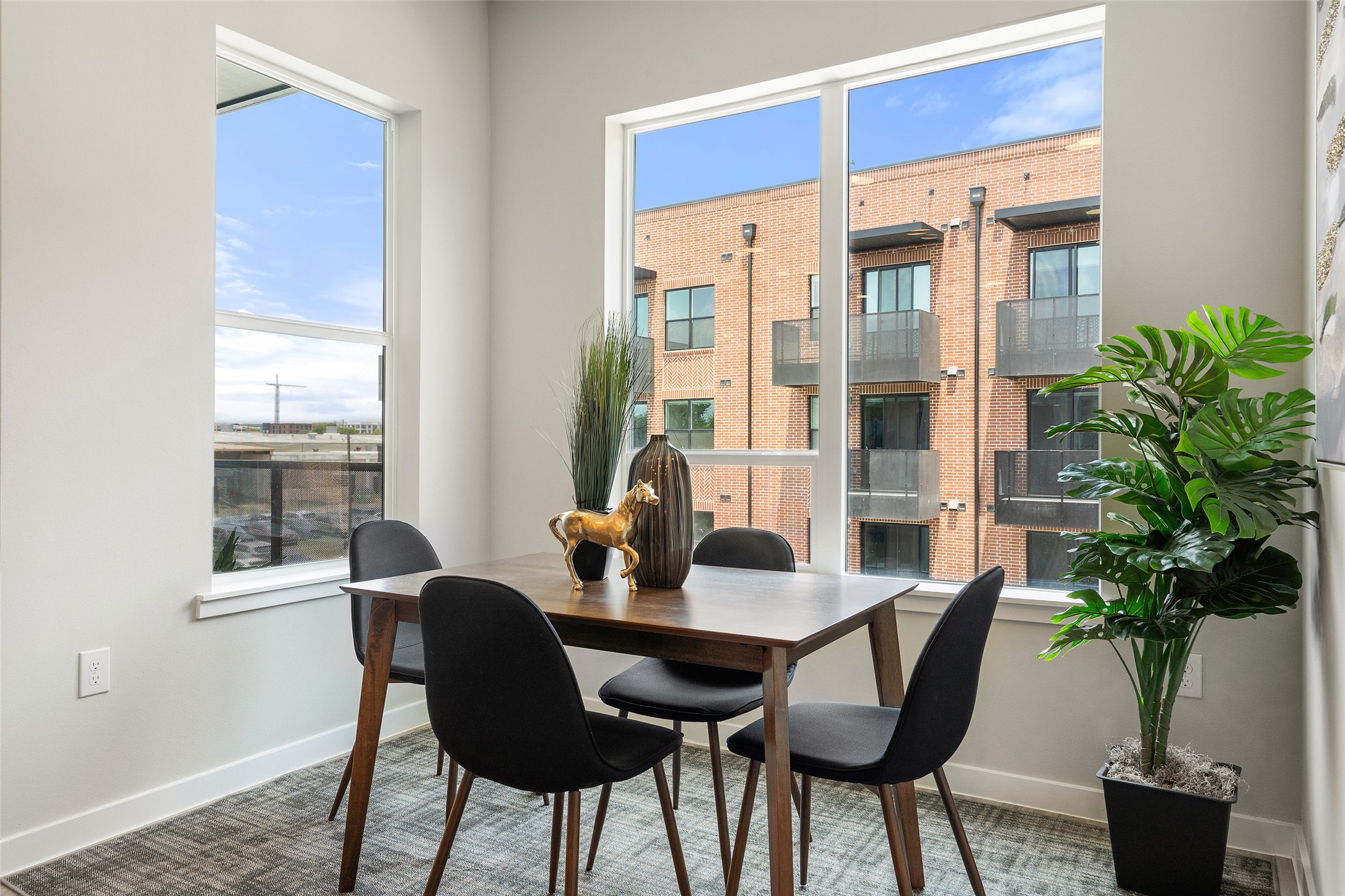 4510 Terry-O Lane, Unit 341 Austin, TX 78745 - Photo 22 of 40 This dining area features a large window providing natural light, light gray walls, and a patterned area rug