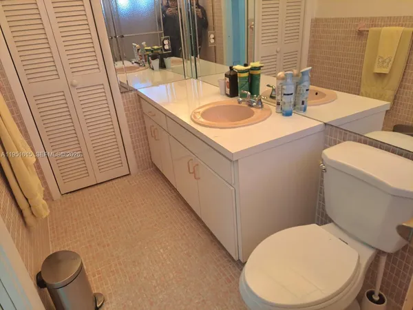 a bathroom with a sink a toilet and mirror