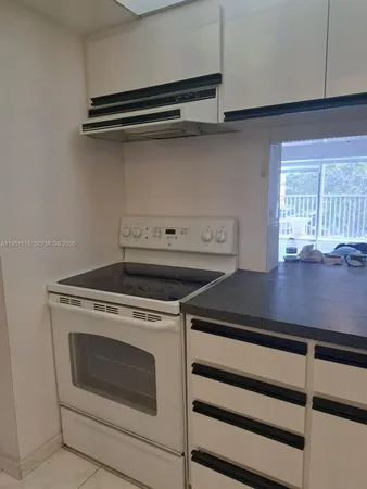 a stove top oven sitting inside of a kitchen
