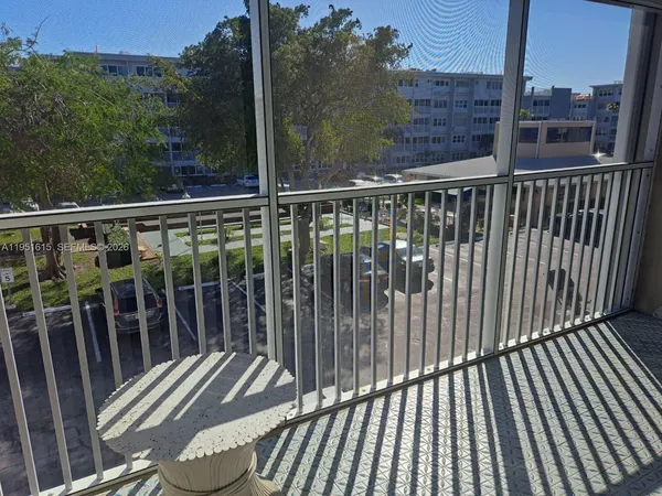 a view of a balcony with wooden floor