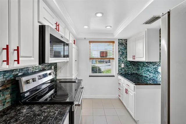 a kitchen with a sink and potted plant