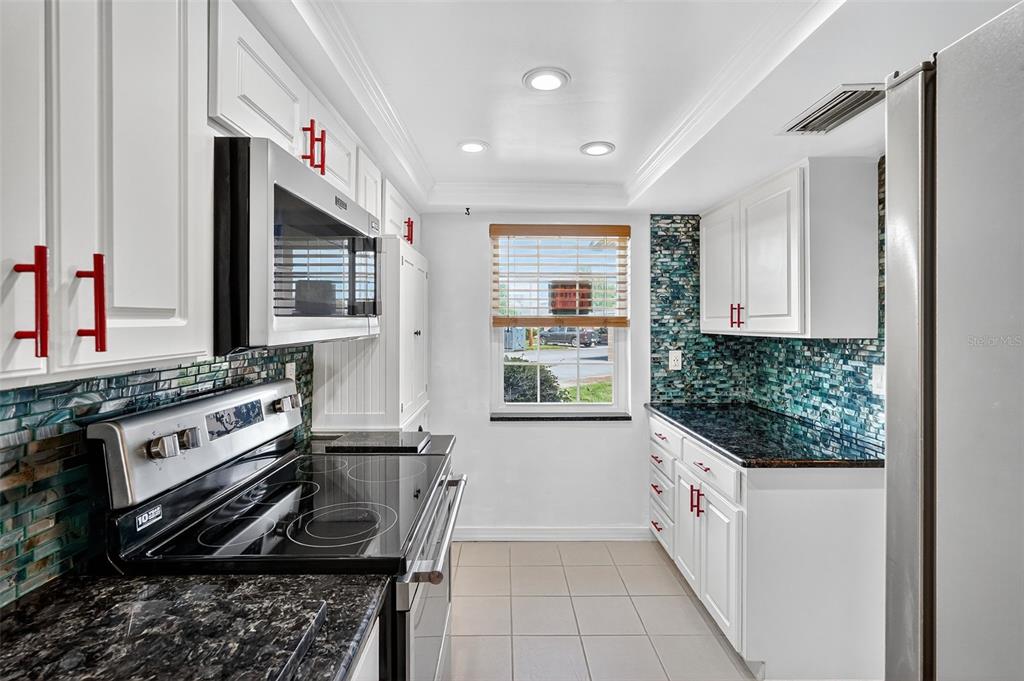 4301 Summersun Drive, Unit A New Port Richey, FL 34652 - Photo 12 of 35 a kitchen with stainless steel appliances a stove and a refrigerator