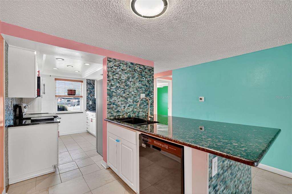 4301 Summersun Drive, Unit A New Port Richey, FL 34652 - Photo 14 of 35 a kitchen with a sink and cabinets