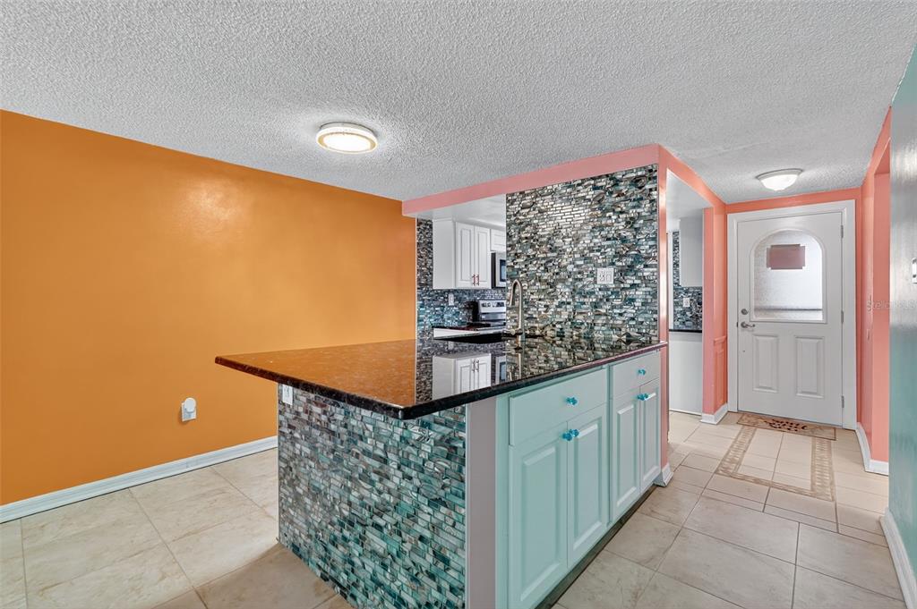 4301 Summersun Drive, Unit A New Port Richey, FL 34652 - Photo 15 of 35 a kitchen with stainless steel appliances granite countertop a sink and cabinets