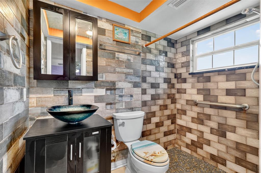 4301 Summersun Drive, Unit A New Port Richey, FL 34652 - Photo 26 of 35 a bathroom with a toilet a sink and a shower