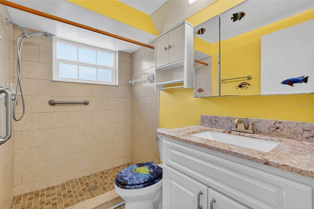 4301 Summersun Drive, Unit A New Port Richey, FL 34652 - Photo 28 of 35 a bathroom with a granite countertop sink and a mirror