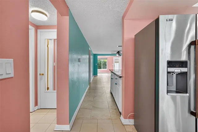 a hallway with cabinets a stove and a window
