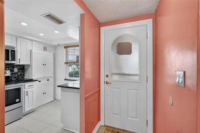 a kitchen with stainless steel appliances granite countertop a refrigerator stove and sink
