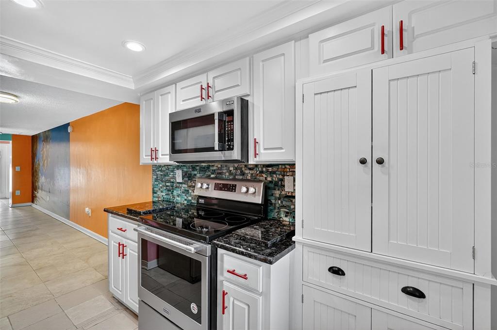 4301 Summersun Drive, Unit A New Port Richey, FL 34652 - Photo 10 of 35 a kitchen with stainless steel appliances white cabinets and stove