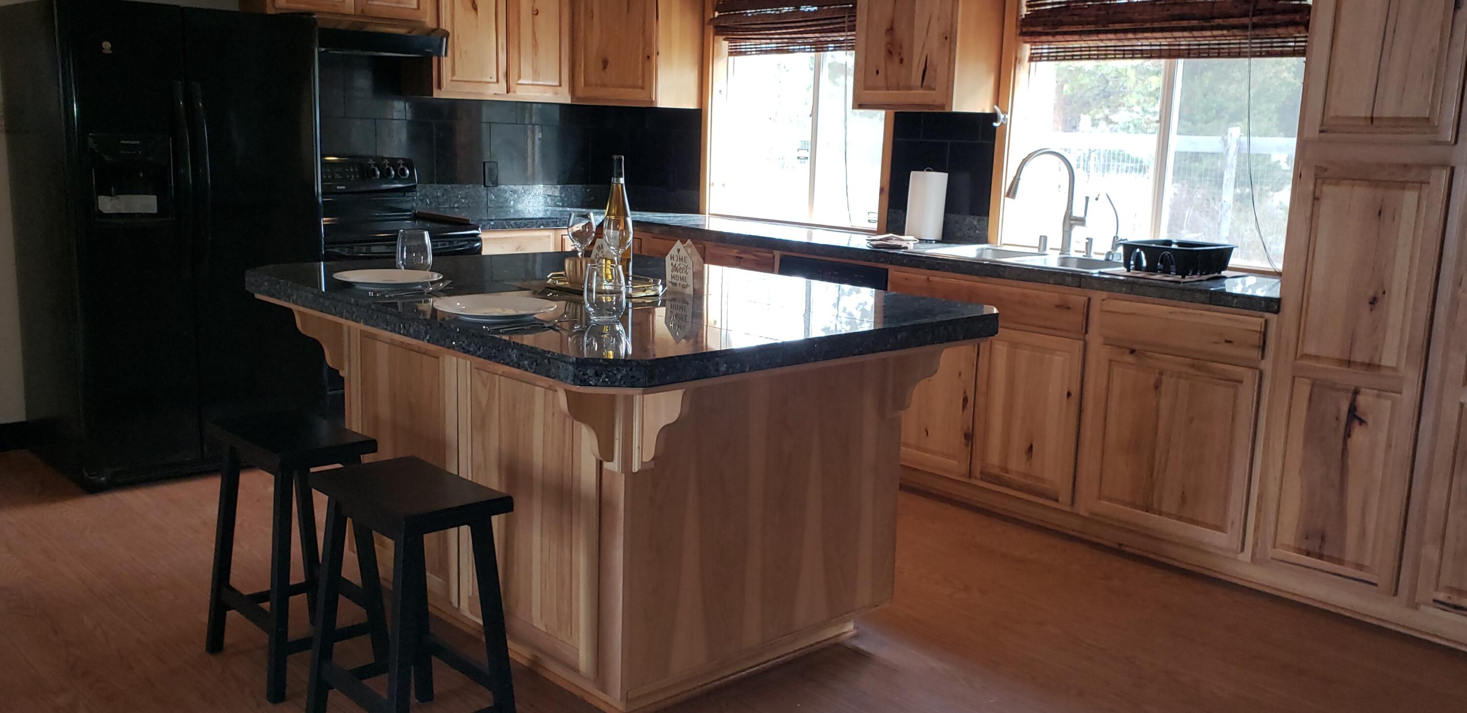 132860 Highway 97 Crescent, OR 97733 - Photo 7 of 25 a kitchen with granite countertop a sink stove and cabinets