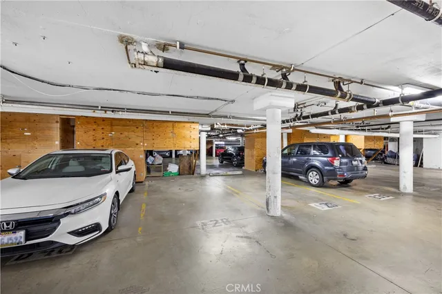 a view of parking garage with cars