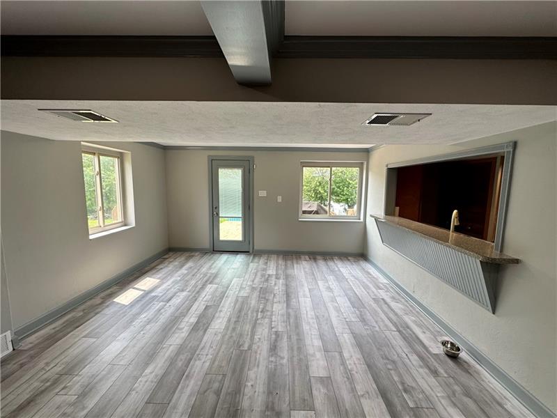5990 Mellon Road Export, PA 15632 - Photo 8 of 20 a view of an empty room with wooden floor and a window