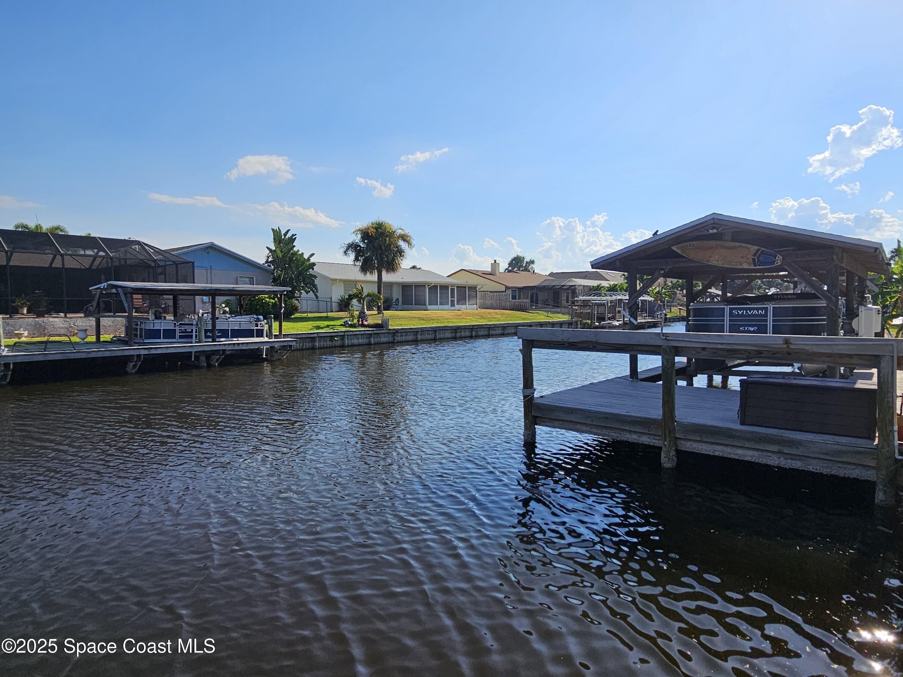1525 West Riviera Drive Merritt Island, FL 32952 - Photo 1 of 47 a view of a lake with a terrace