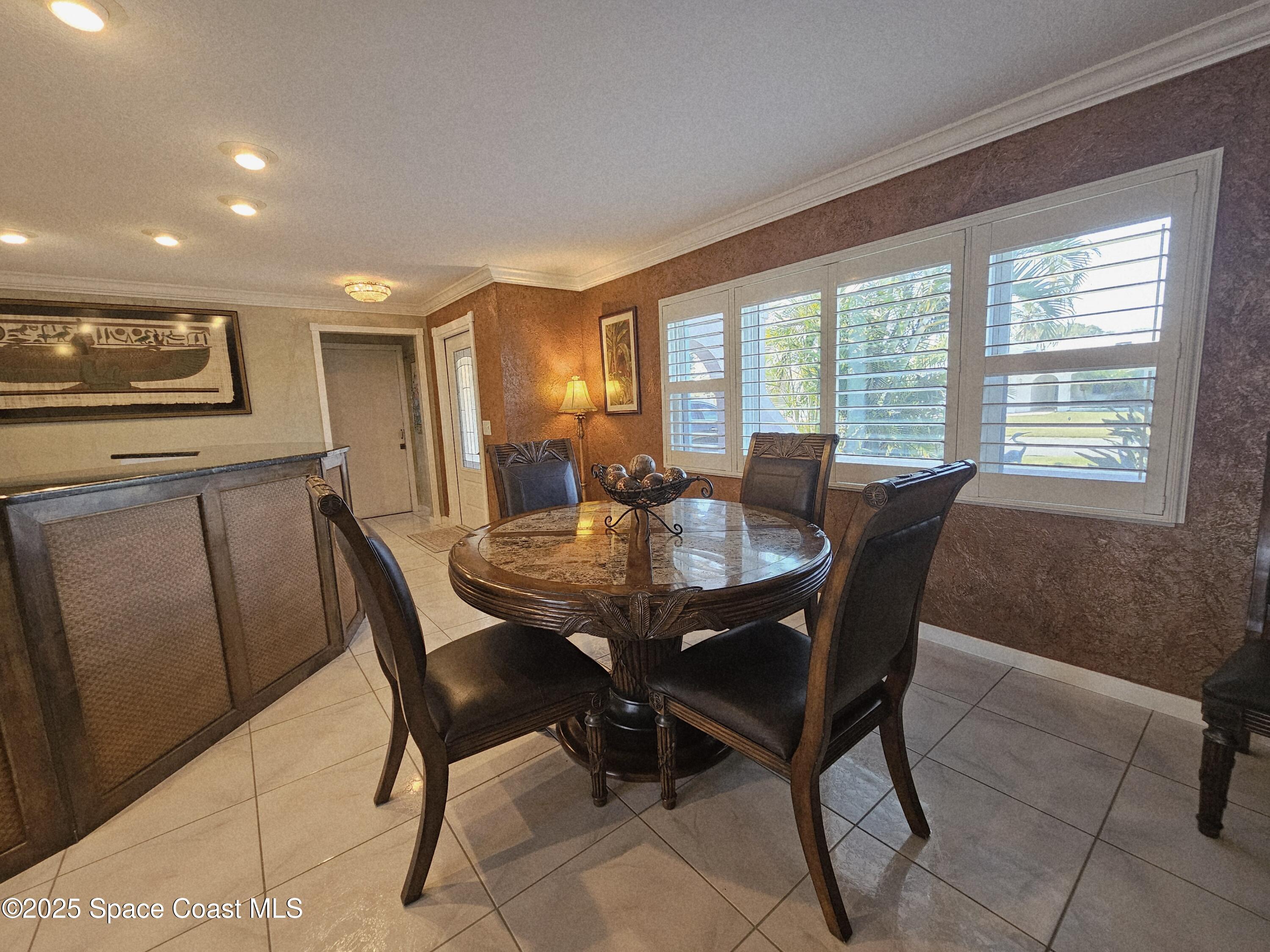 1525 West Riviera Drive Merritt Island, FL 32952 - Photo 11 of 47 a view of a dining room with furniture and window