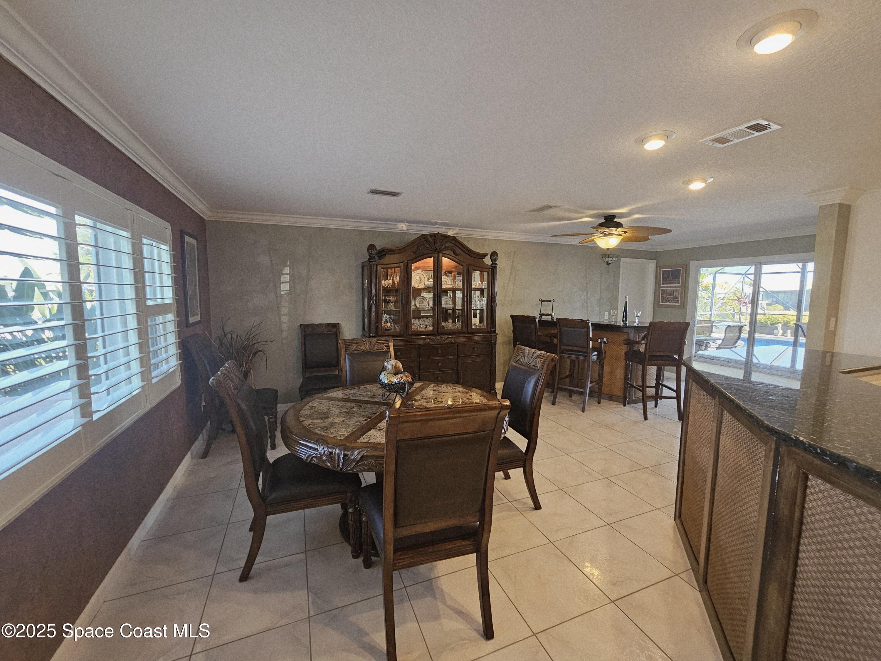 1525 West Riviera Drive Merritt Island, FL 32952 - Photo 12 of 47 a view of a dining room with furniture window and outside view