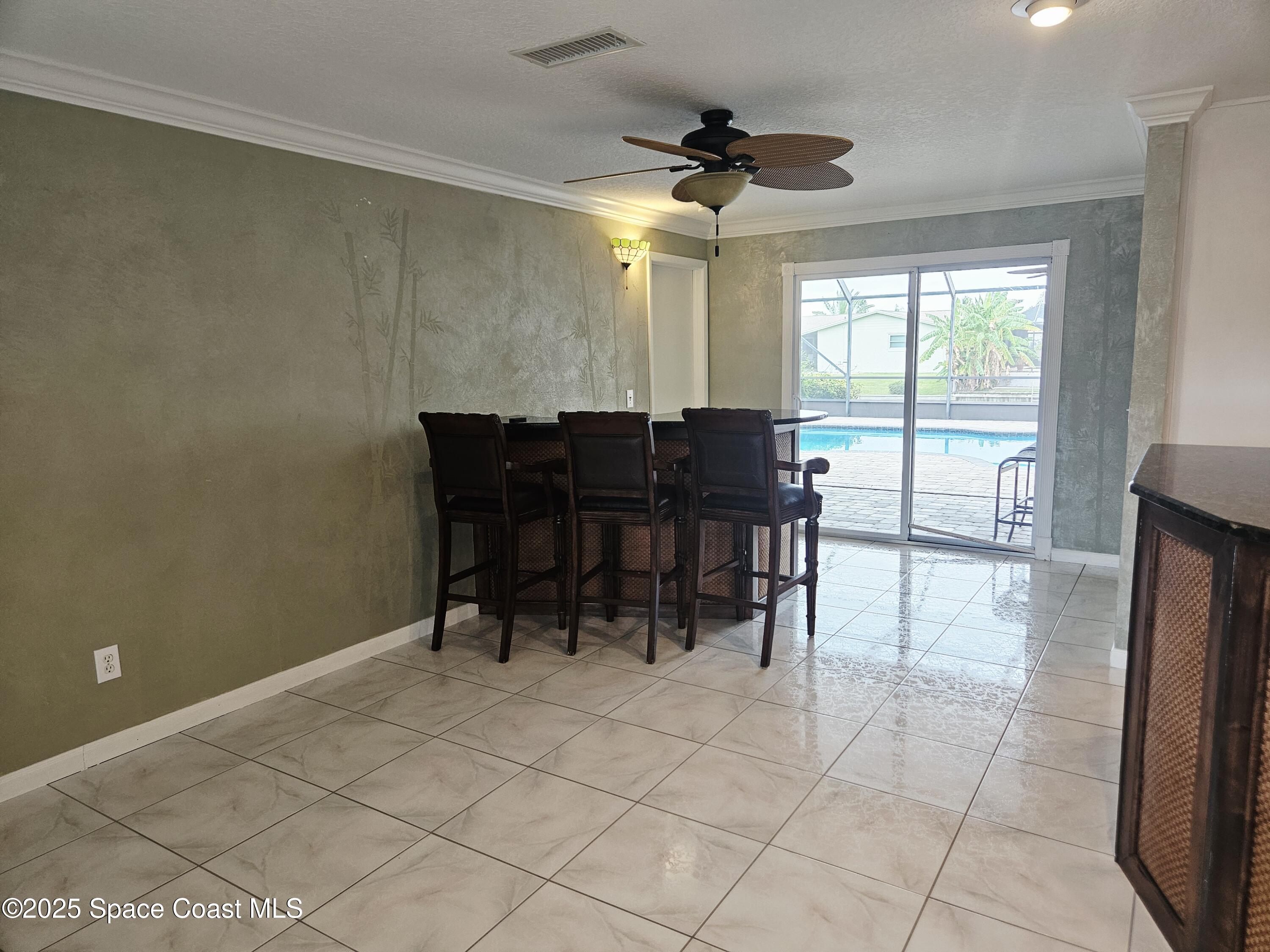 1525 West Riviera Drive Merritt Island, FL 32952 - Photo 14 of 47 a view of a dining room with furniture and chandelier