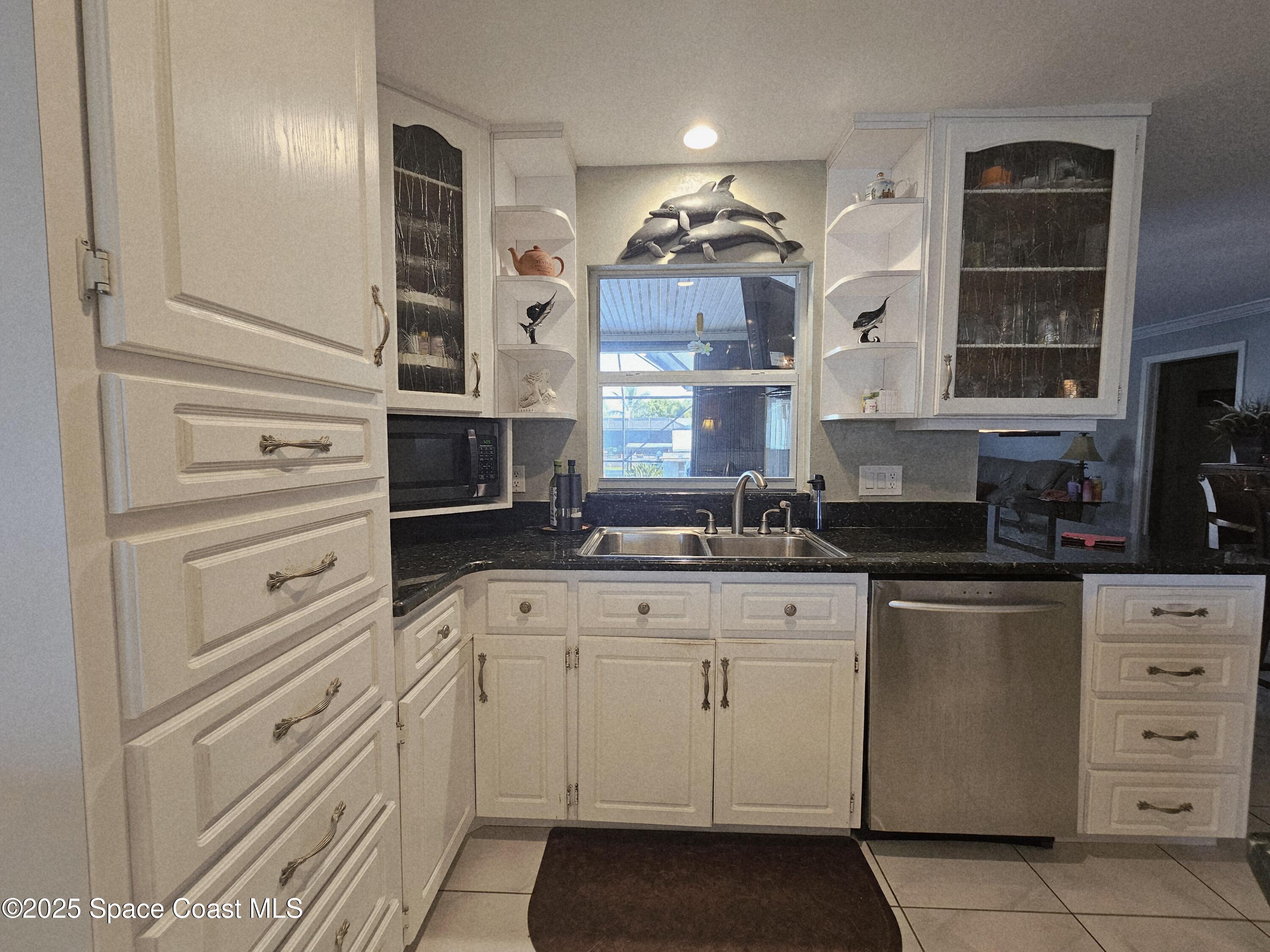 1525 West Riviera Drive Merritt Island, FL 32952 - Photo 16 of 47 a kitchen with cabinets stainless steel appliances and a window