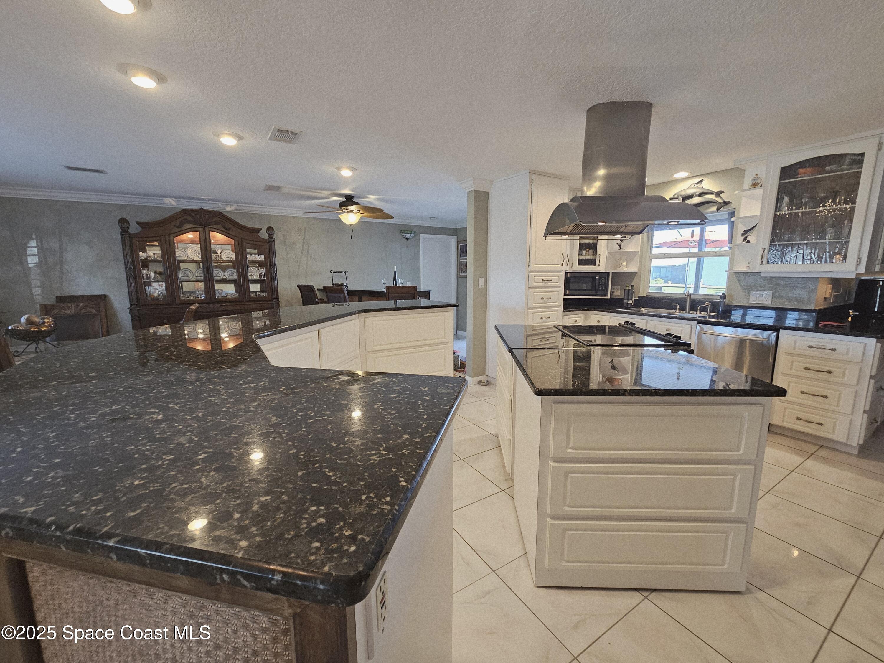 1525 West Riviera Drive Merritt Island, FL 32952 - Photo 17 of 47 a kitchen with stainless steel appliances granite countertop a sink and a white stove