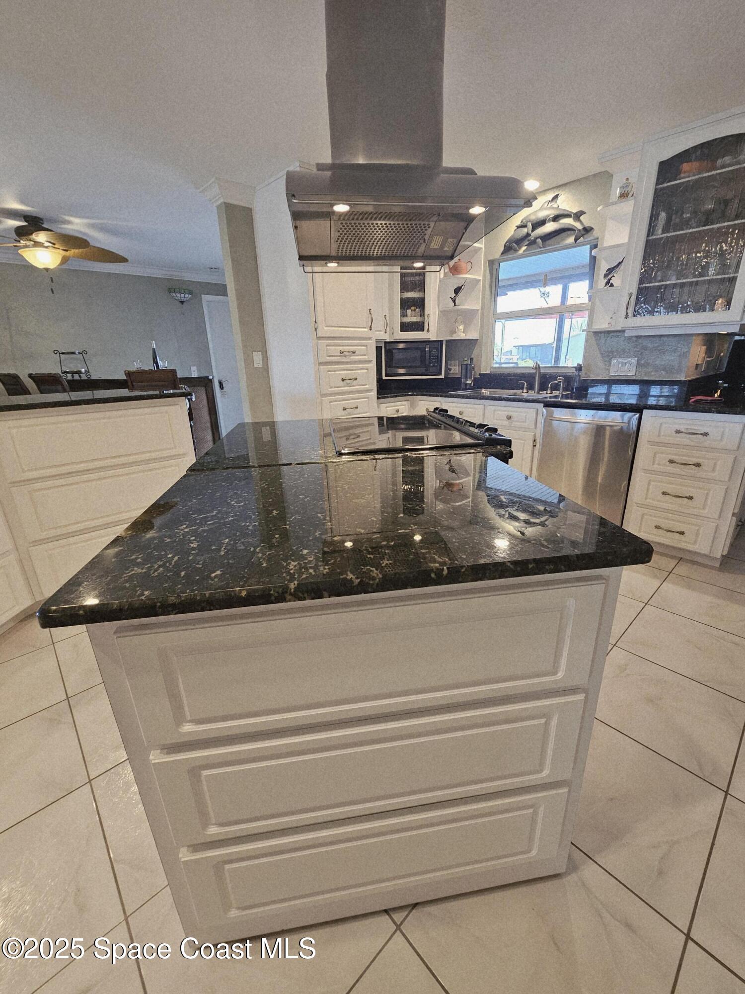 1525 West Riviera Drive Merritt Island, FL 32952 - Photo 18 of 47 a kitchen with kitchen island a counter top and stove