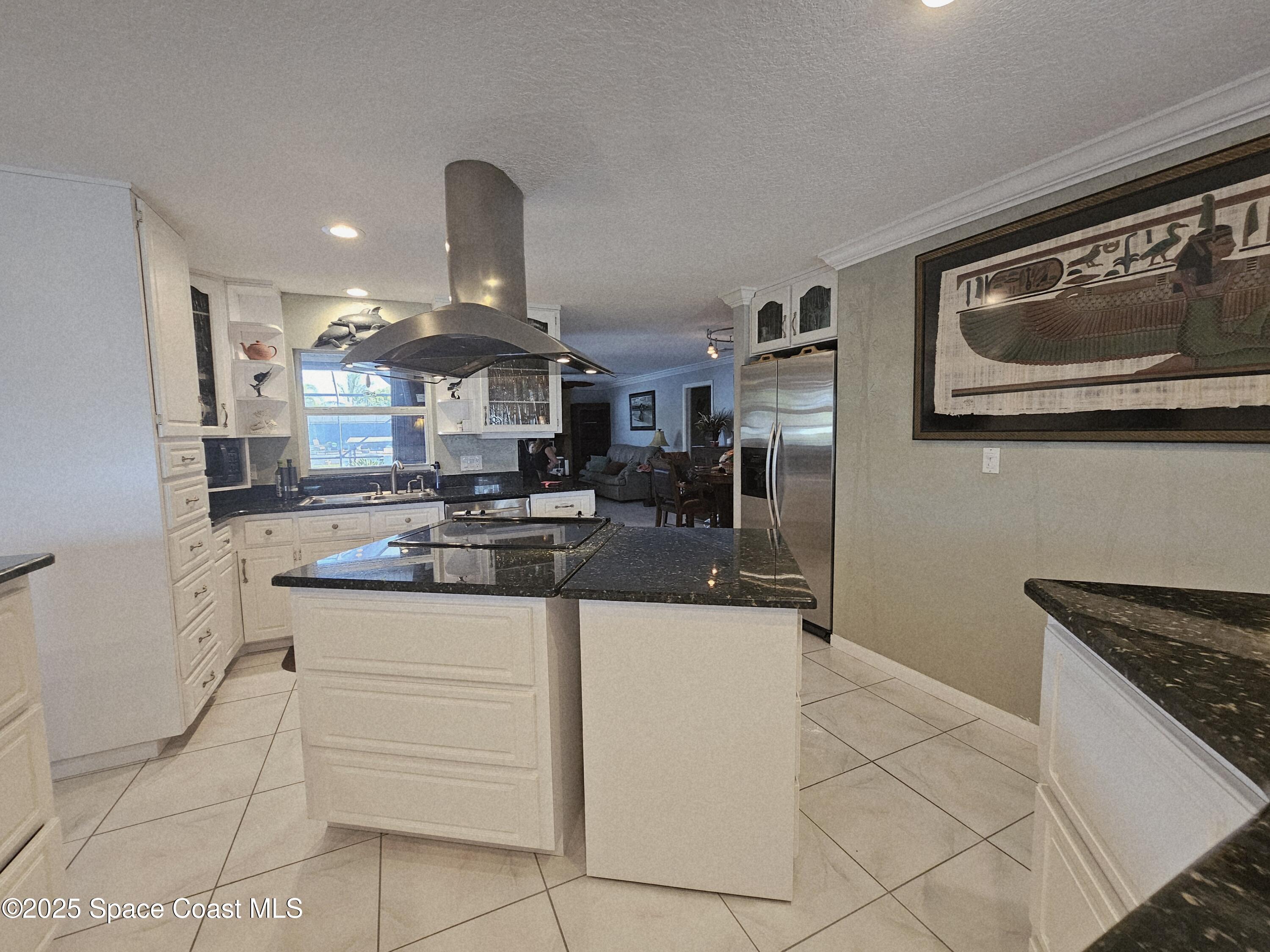 1525 West Riviera Drive Merritt Island, FL 32952 - Photo 19 of 47 a kitchen with stainless steel appliances granite countertop a sink and cabinets