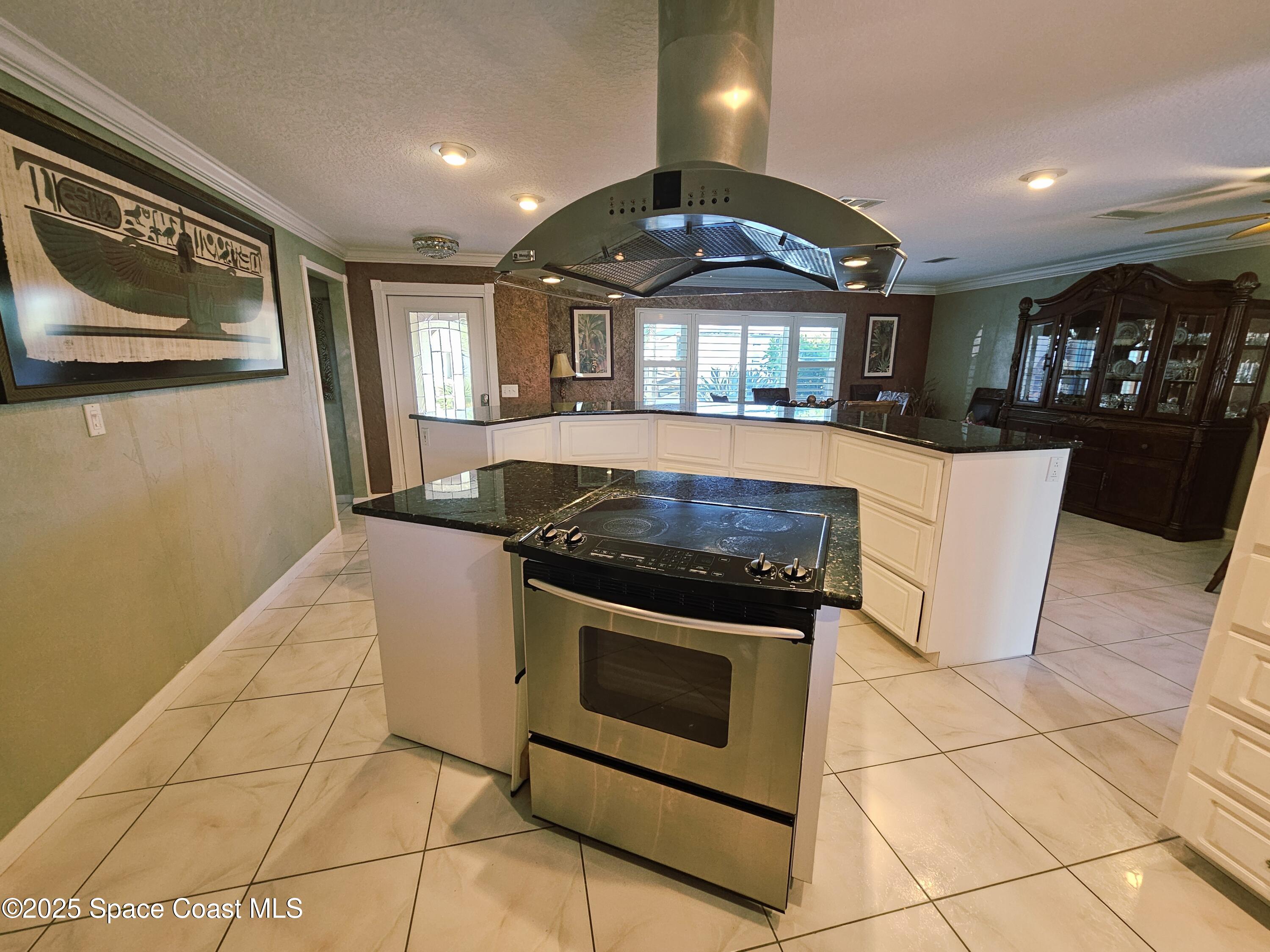 1525 West Riviera Drive Merritt Island, FL 32952 - Photo 22 of 47 a kitchen with granite countertop a stove a sink and a refrigerator