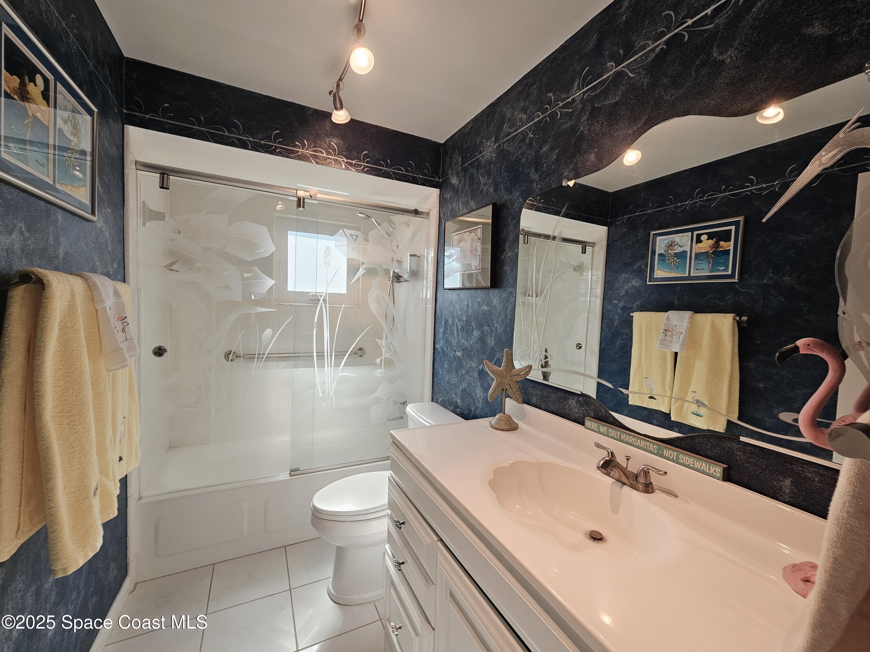 1525 West Riviera Drive Merritt Island, FL 32952 - Photo 28 of 47 a bathroom with a sink a toilet and shower