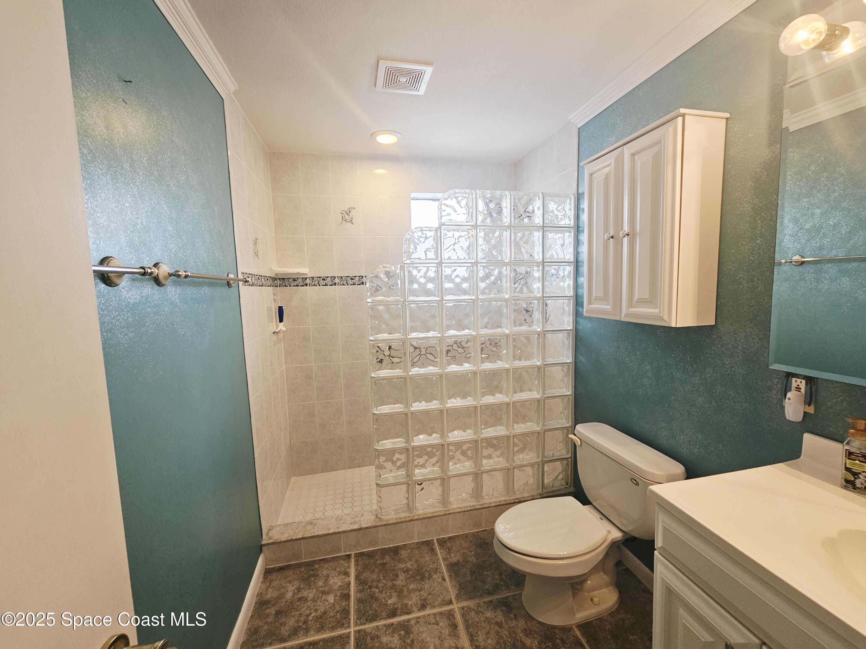 1525 West Riviera Drive Merritt Island, FL 32952 - Photo 30 of 47 a bathroom with a toilet and a shower