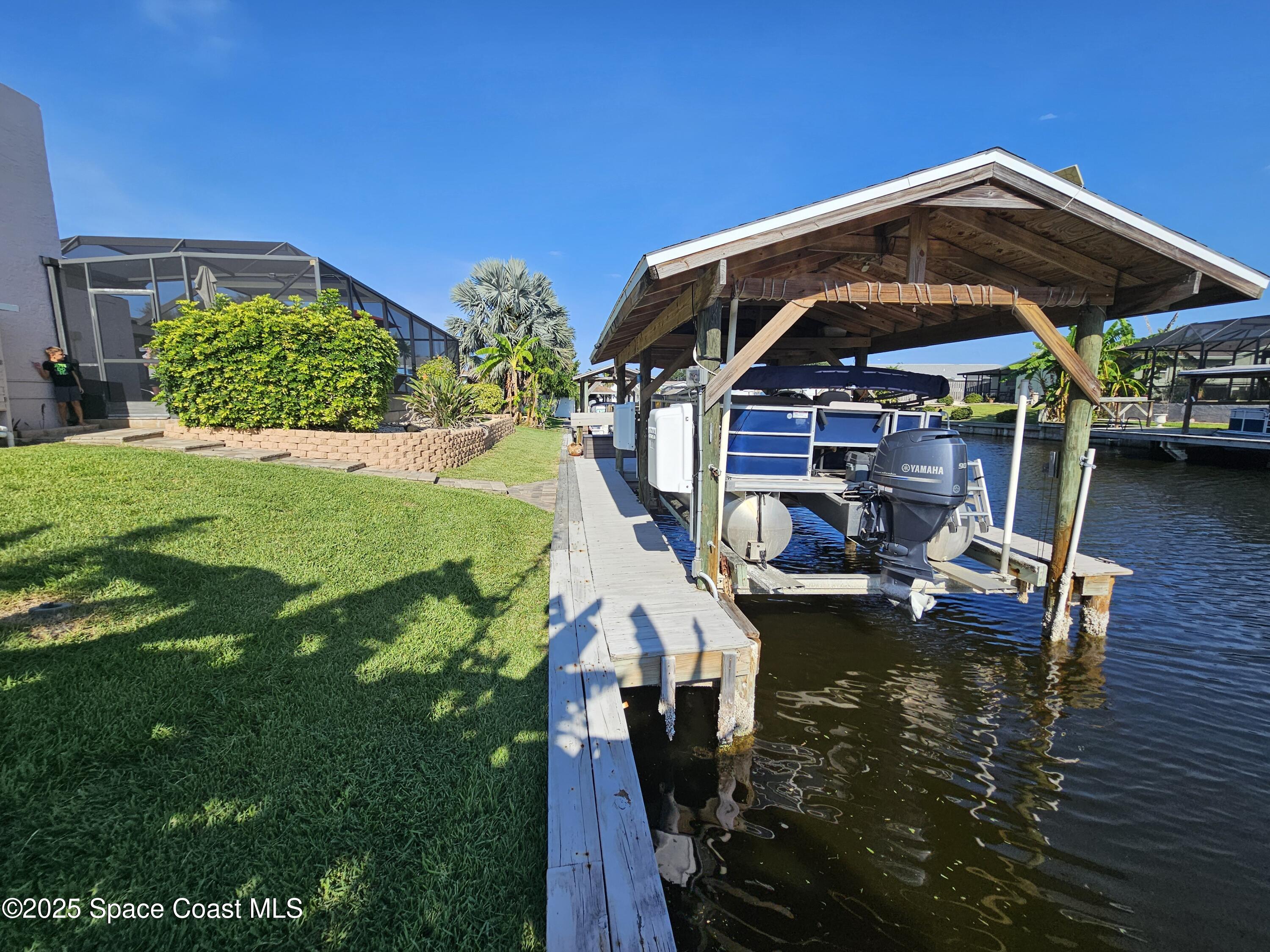 1525 West Riviera Drive Merritt Island, FL 32952 - Photo 33 of 47 a view of a house with a yard