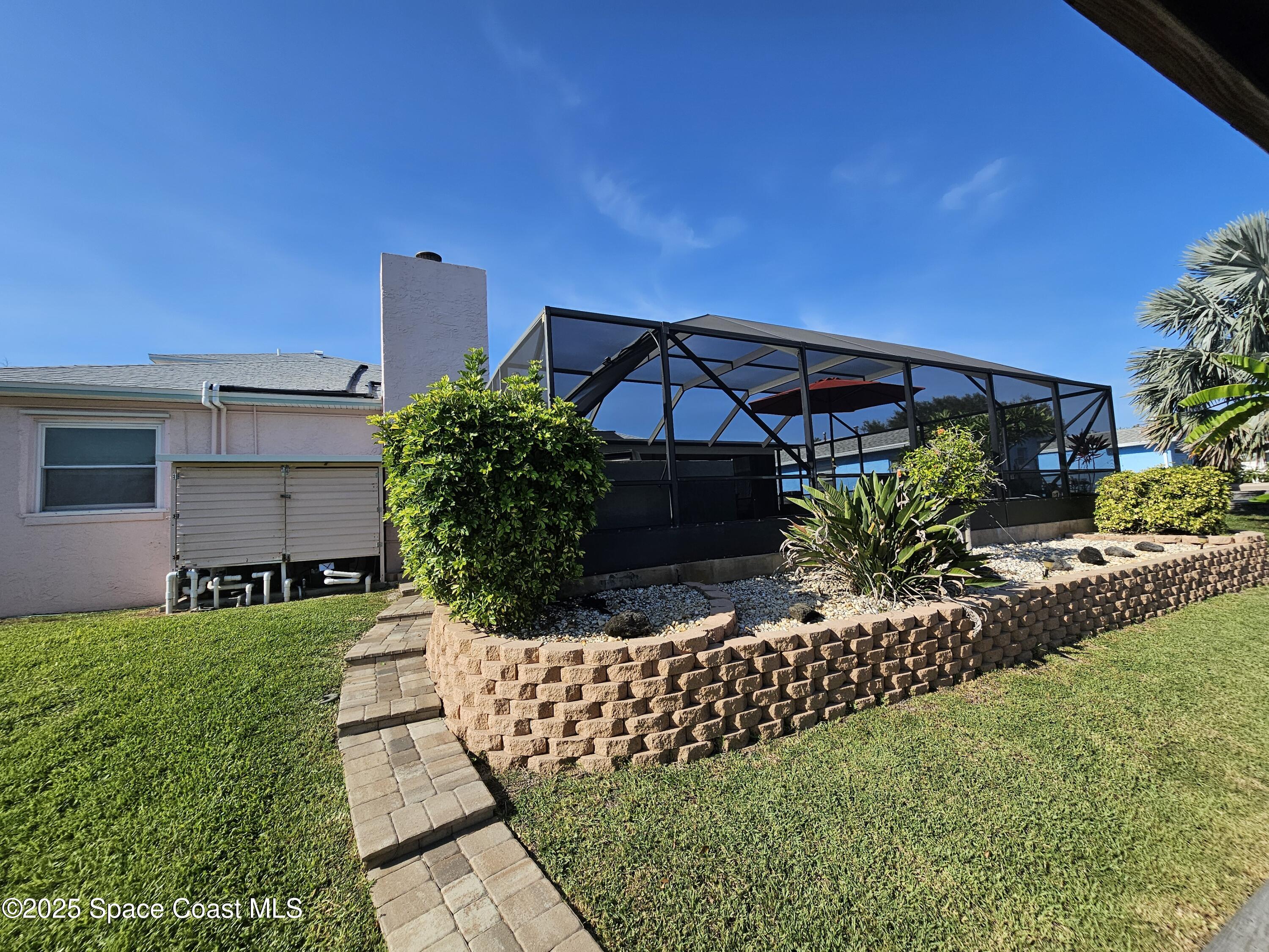 1525 West Riviera Drive Merritt Island, FL 32952 - Photo 34 of 47 a front view of a house with garden