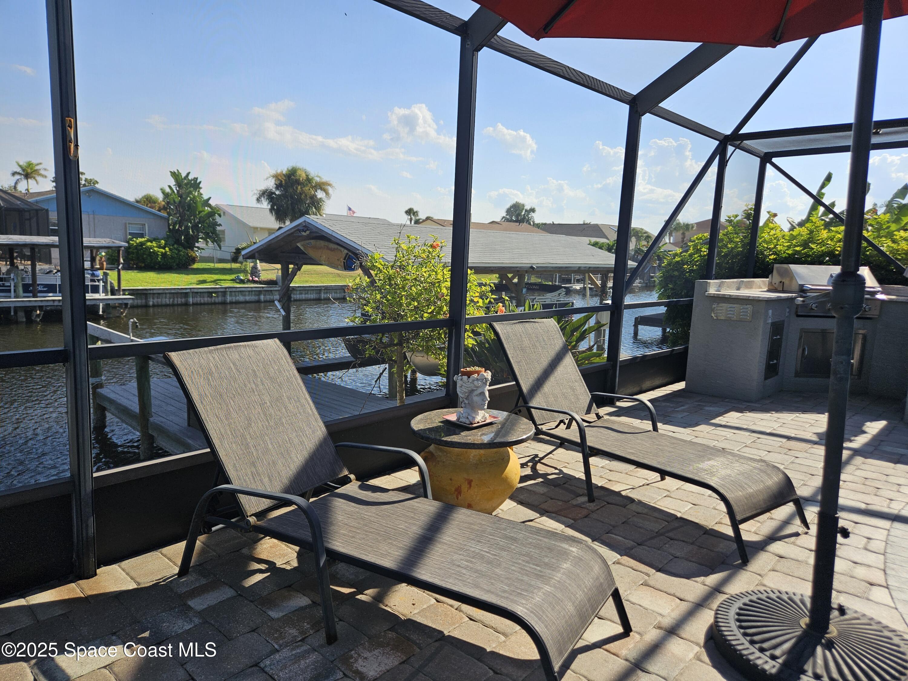 1525 West Riviera Drive Merritt Island, FL 32952 - Photo 37 of 47 a view of a balcony with chairs and wooden floor