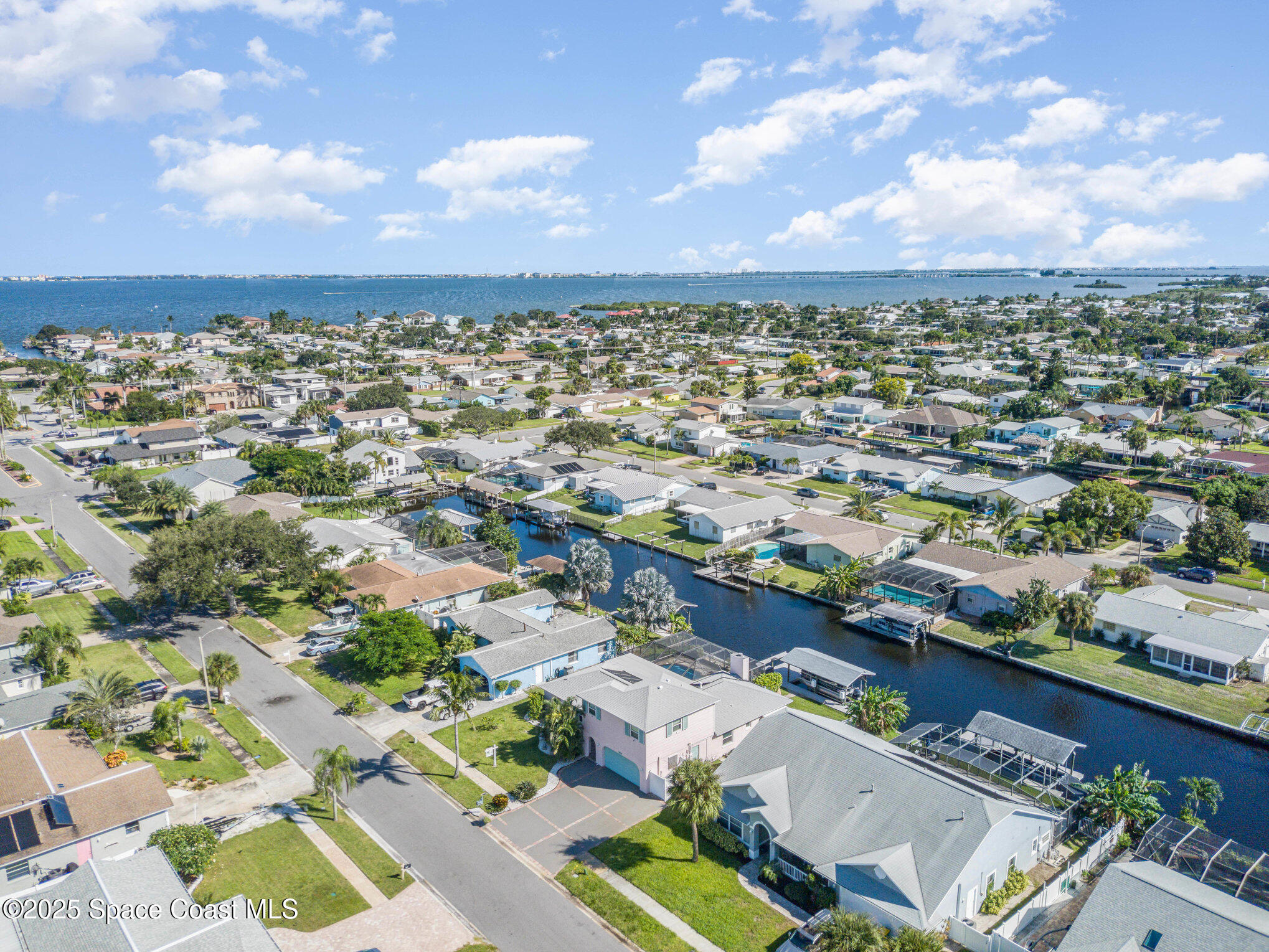 1525 West Riviera Drive Merritt Island, FL 32952 - Photo 43 of 47 an aerial view of a city with lots of residential buildings
