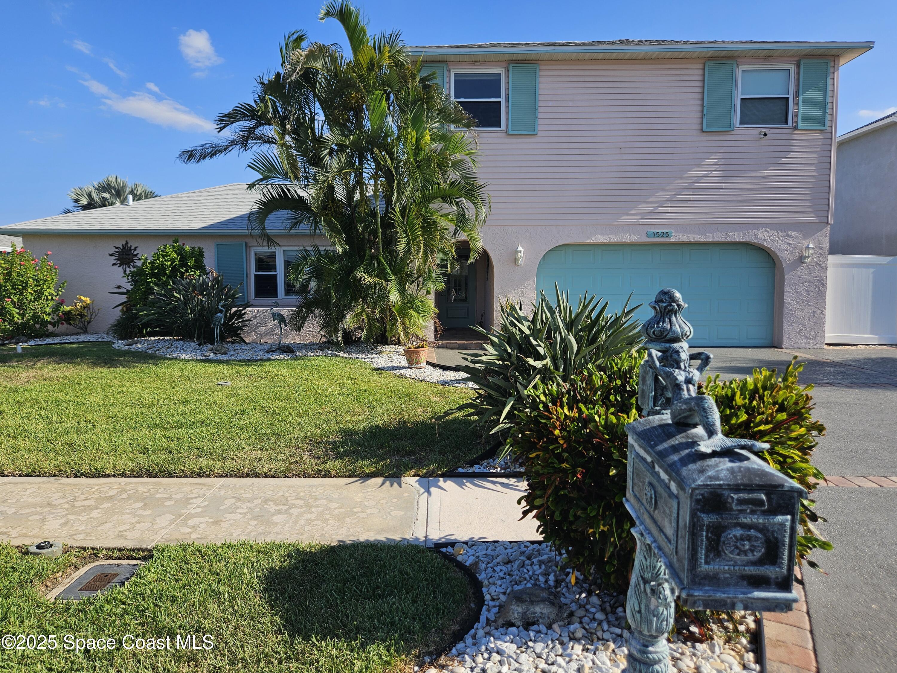 1525 West Riviera Drive Merritt Island, FL 32952 - Photo 6 of 47 a front view of a house with a yard