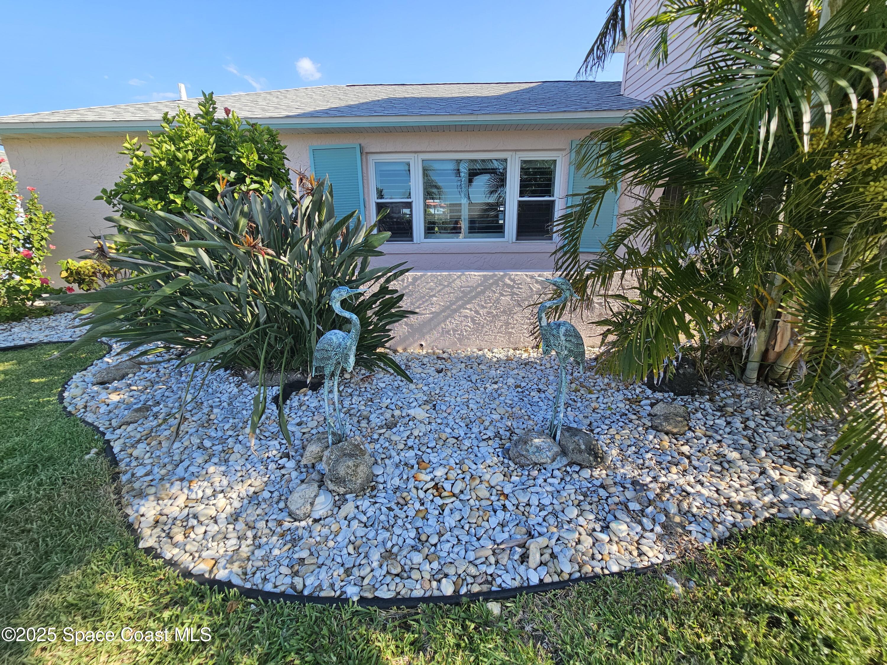1525 West Riviera Drive Merritt Island, FL 32952 - Photo 9 of 47 a front view of a house with garden