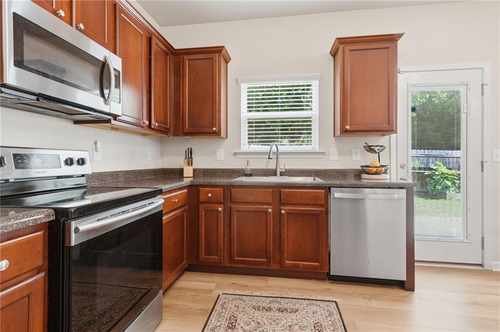 123 Renford Road Ball Ground, GA 30107 - Photo 10 of 27 a kitchen with stainless steel appliances granite countertop a stove a sink and a microwave