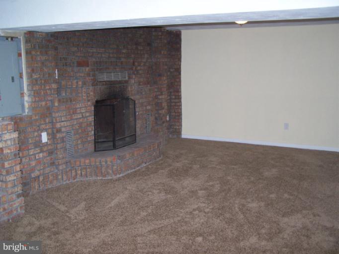 8908 Crandall Road Lanham, MD 20706 - Photo 21 of 30 Finished Bsm't Family Room w/ FP & brick wall