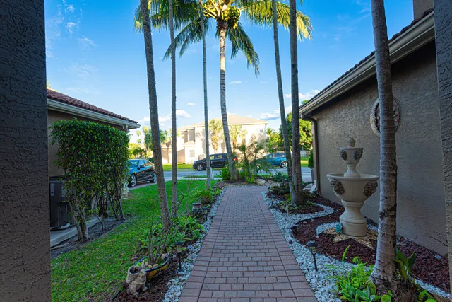 a kitchen with stainless steel appliances kitchen island granite countertop a refrigerator and a stove top oven