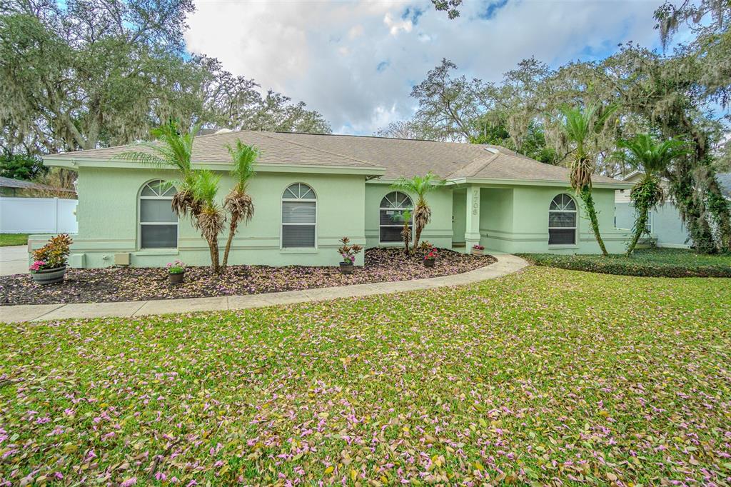 7708 Merrily Way Lakeland, FL 33809 - Photo 1 of 41 a front view of a house with garden