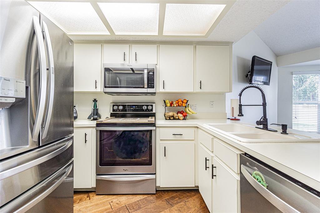 7708 Merrily Way Lakeland, FL 33809 - Photo 15 of 41 a kitchen with a sink stove and refrigerator
