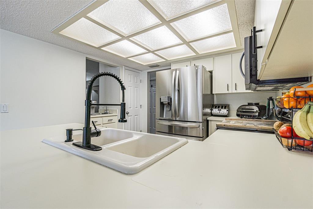 7708 Merrily Way Lakeland, FL 33809 - Photo 17 of 41 a kitchen with stainless steel appliances a sink and cabinets