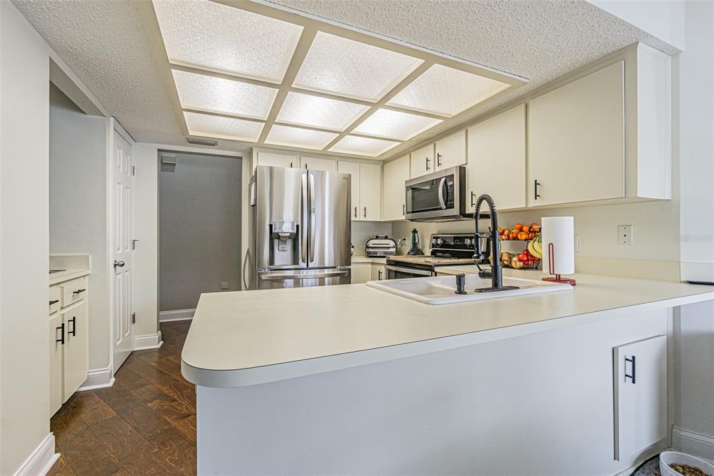7708 Merrily Way Lakeland, FL 33809 - Photo 19 of 41 a kitchen with stainless steel appliances a refrigerator and a stove top oven