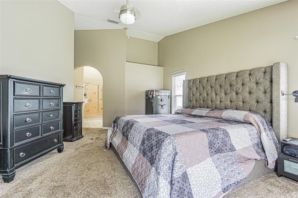 7708 Merrily Way Lakeland, FL 33809 - Photo 21 of 41 a bedroom with a bed and a dresser