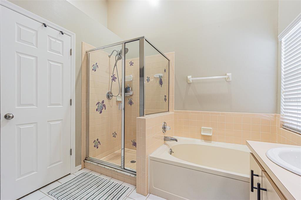 7708 Merrily Way Lakeland, FL 33809 - Photo 24 of 41 a bathroom with a tub a sink and a shower