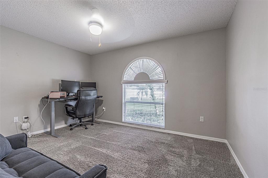 7708 Merrily Way Lakeland, FL 33809 - Photo 27 of 41 a view of a livingroom with workspace and a window
