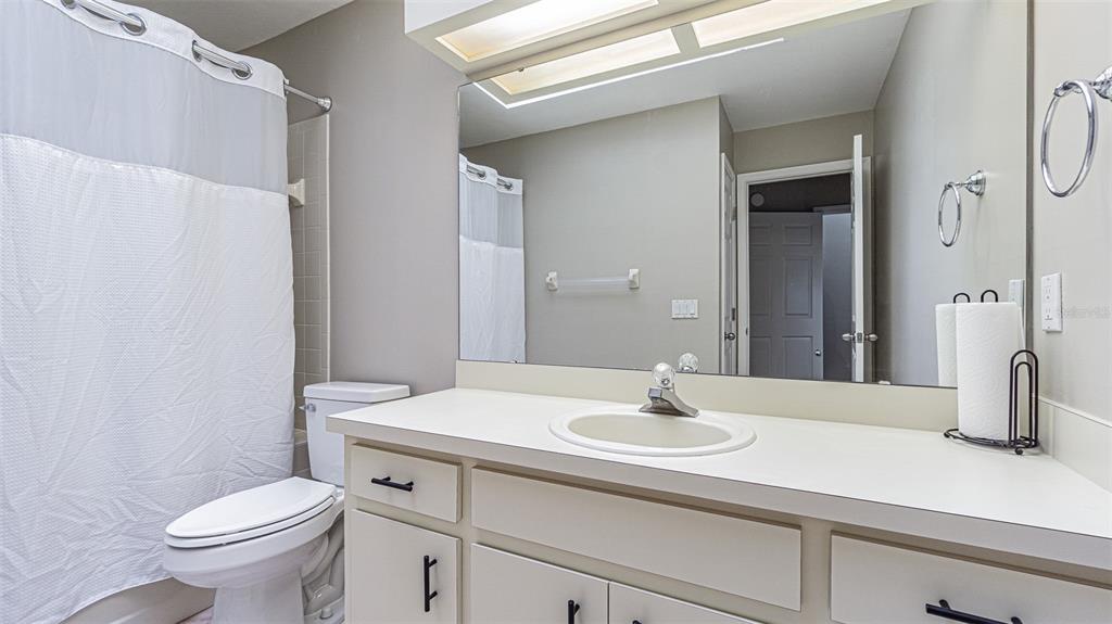 7708 Merrily Way Lakeland, FL 33809 - Photo 28 of 41 a bathroom with a sink toilet and shower