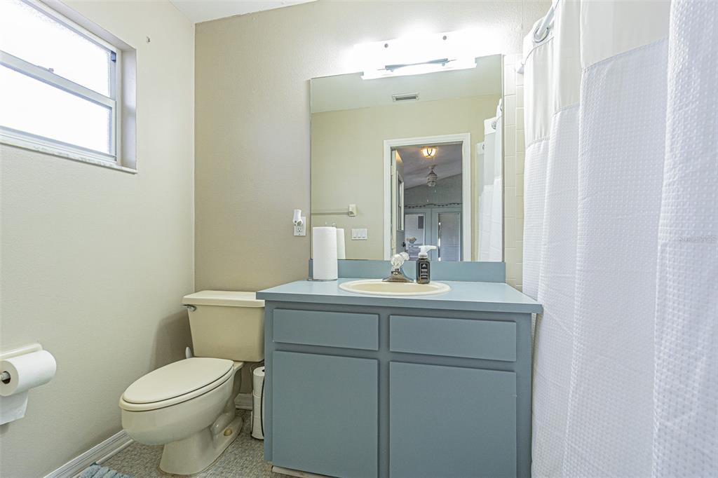 7708 Merrily Way Lakeland, FL 33809 - Photo 33 of 41 a bathroom with a toilet a sink and mirror